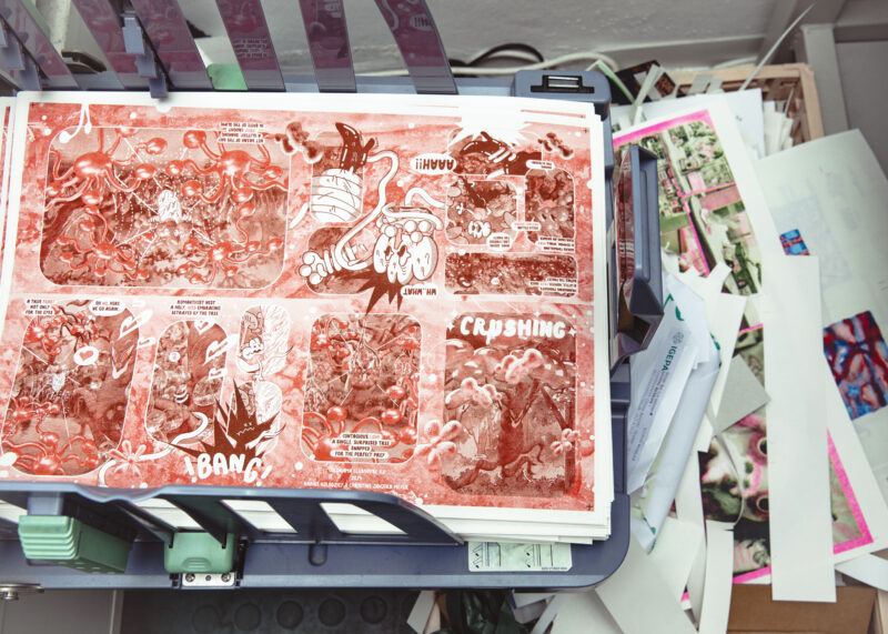 Printer tray holding stacks of a large sheet printed illustration.