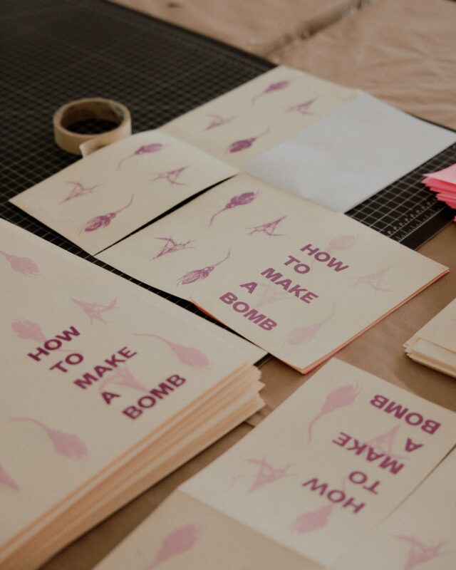 "How to Make a Bomb" cover papers laid out on a table.