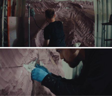 Two images on top of each other, showing two different angles of Trey Abdella sculpting a large, textured pink surface using his hands to sculpts and tools. He is wearing black clothes and blue gloves in an indoor workshop.